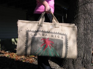Log carriers made from a recycled burlap coffee sack